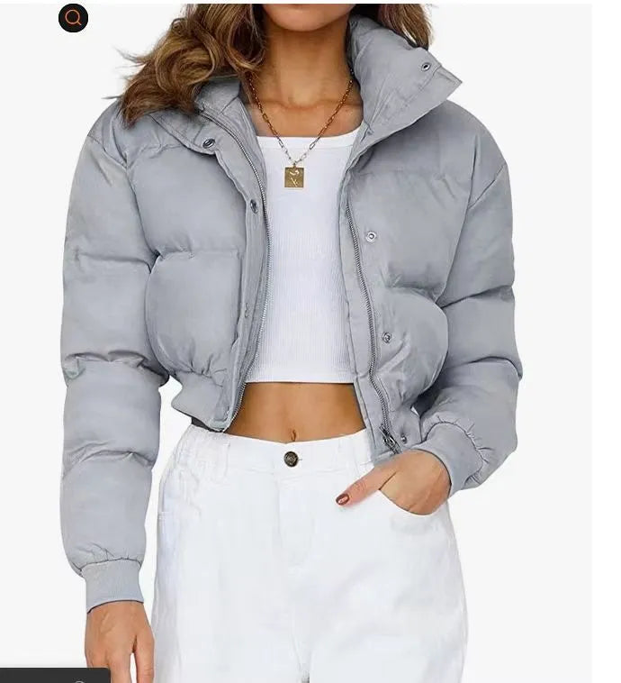 Loose fit blue women's polyester jacket with long sleeves on a hanger