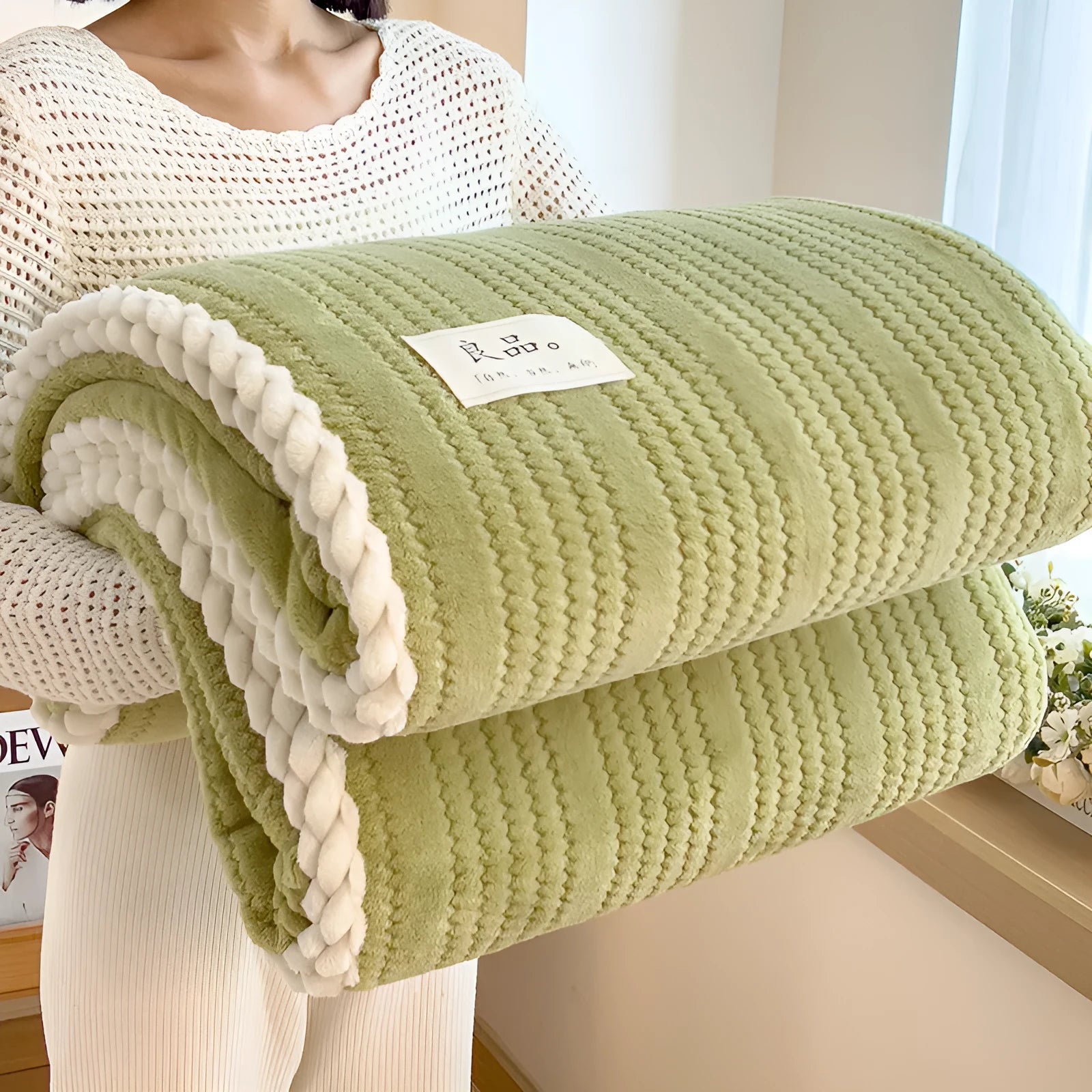 Solid colour jacquard milk velvet blanket in green on a bed with Nordic style decor