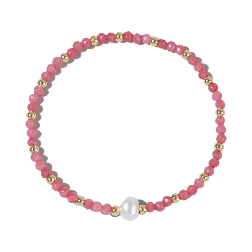 Close-up of a unisex natural stone bracelet with geometric ellipse beads on a wrist.