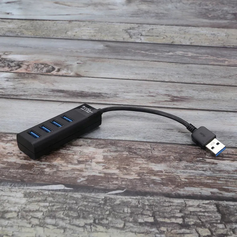 Black USB 3.0 hub with four ports, a 30cm cable, and LED status indicators next to each port.