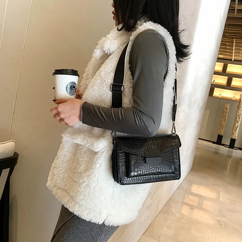 Vintage PU leather crossbody bag in black, shown with a mobile phone and wallet inside