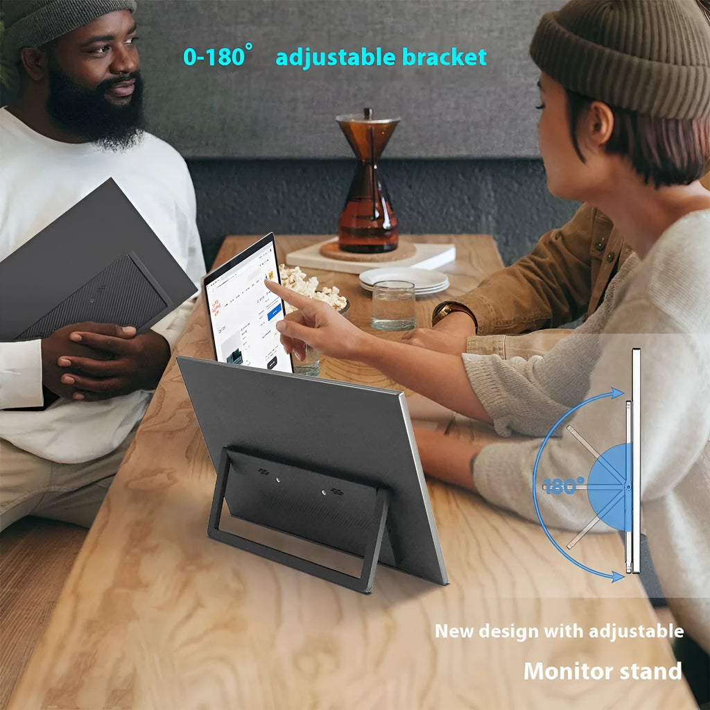 Black 15.6-inch portable USB-C monitor with adjustable stand on a desk next to a laptop