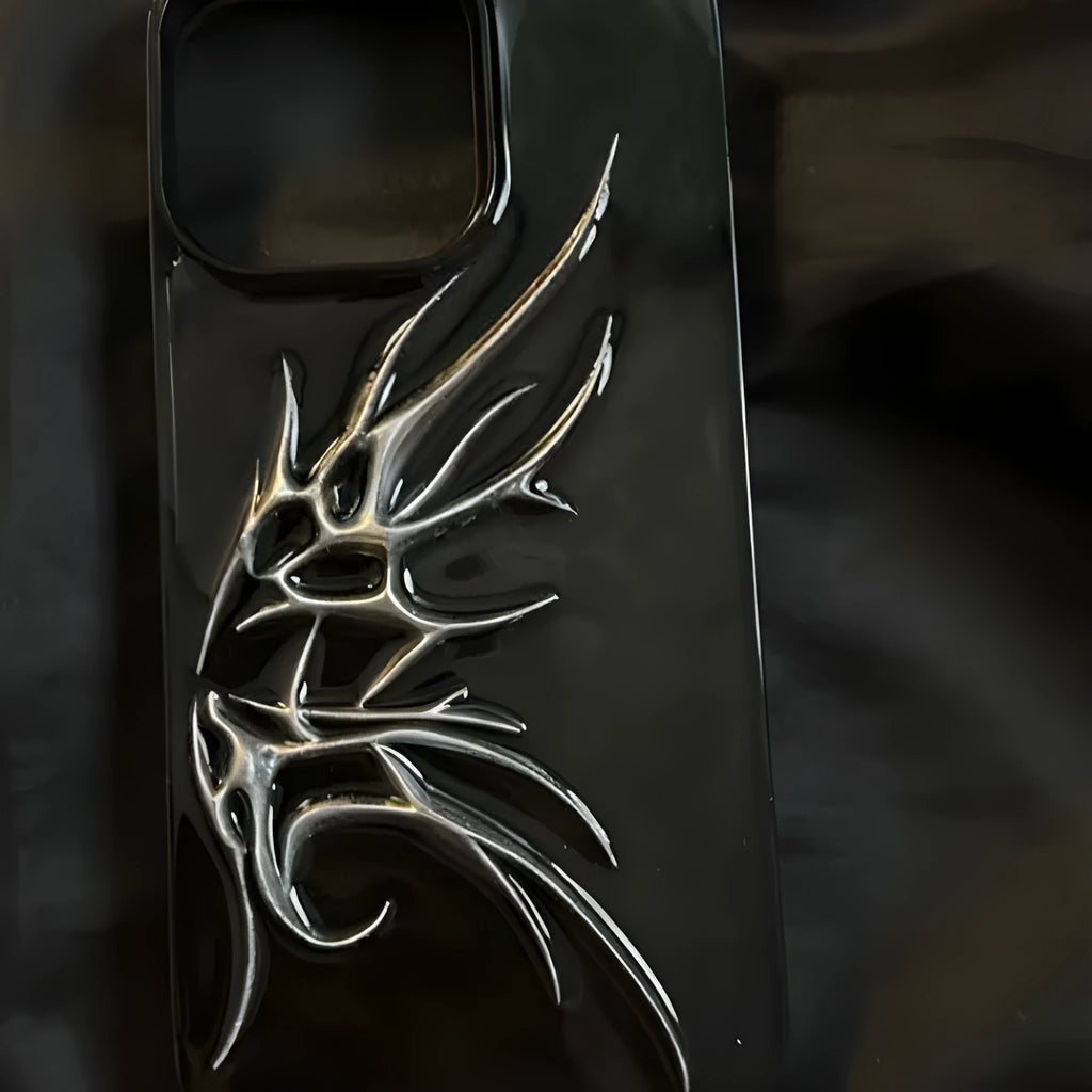 Black iPhone case with three-dimensional wings design showing textured surface