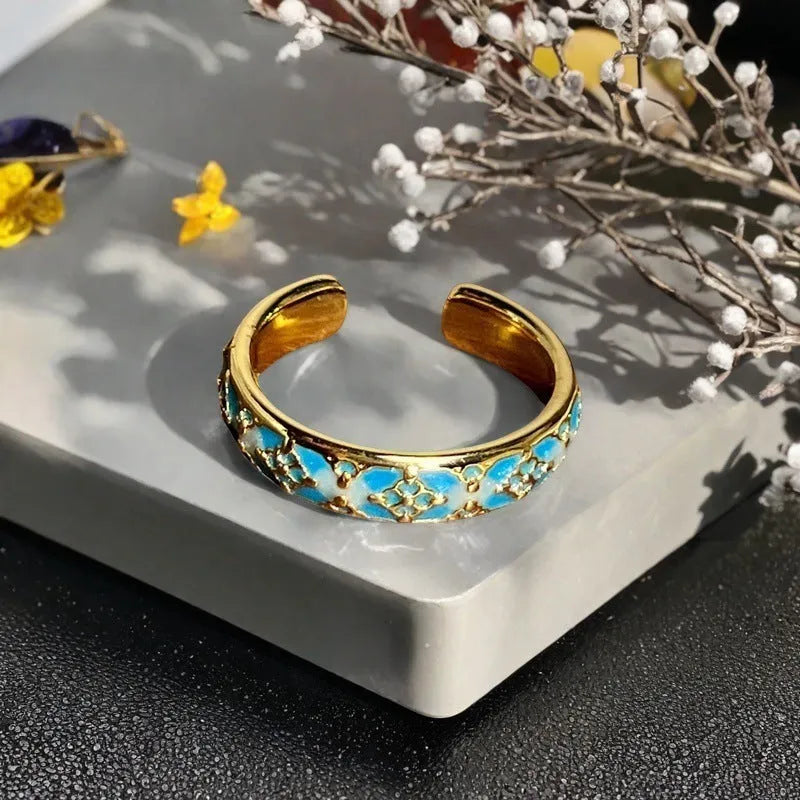 Adjustable copper ring with vintage gourd, flower, and bow design, inlaid with zircon stones.