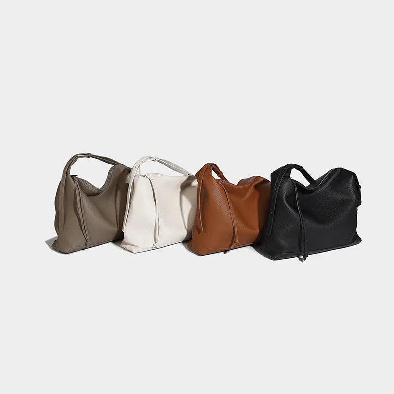 Soft PU leather messenger bag in caramel colour showing large capacity and shoulder strap.