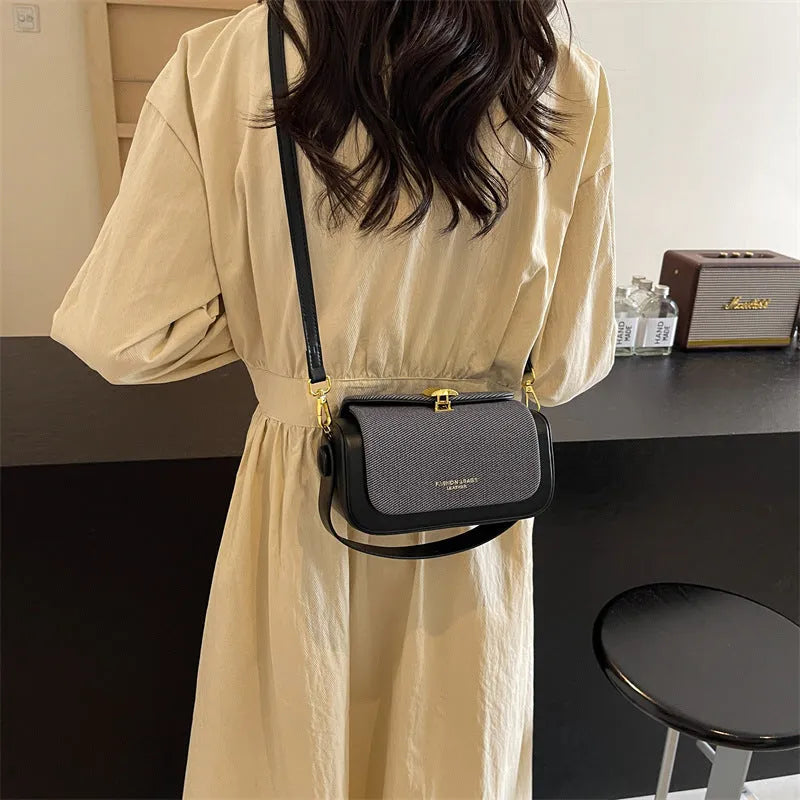 Women's black PU leather crossbody messenger bag with contrast stitching and lock detail