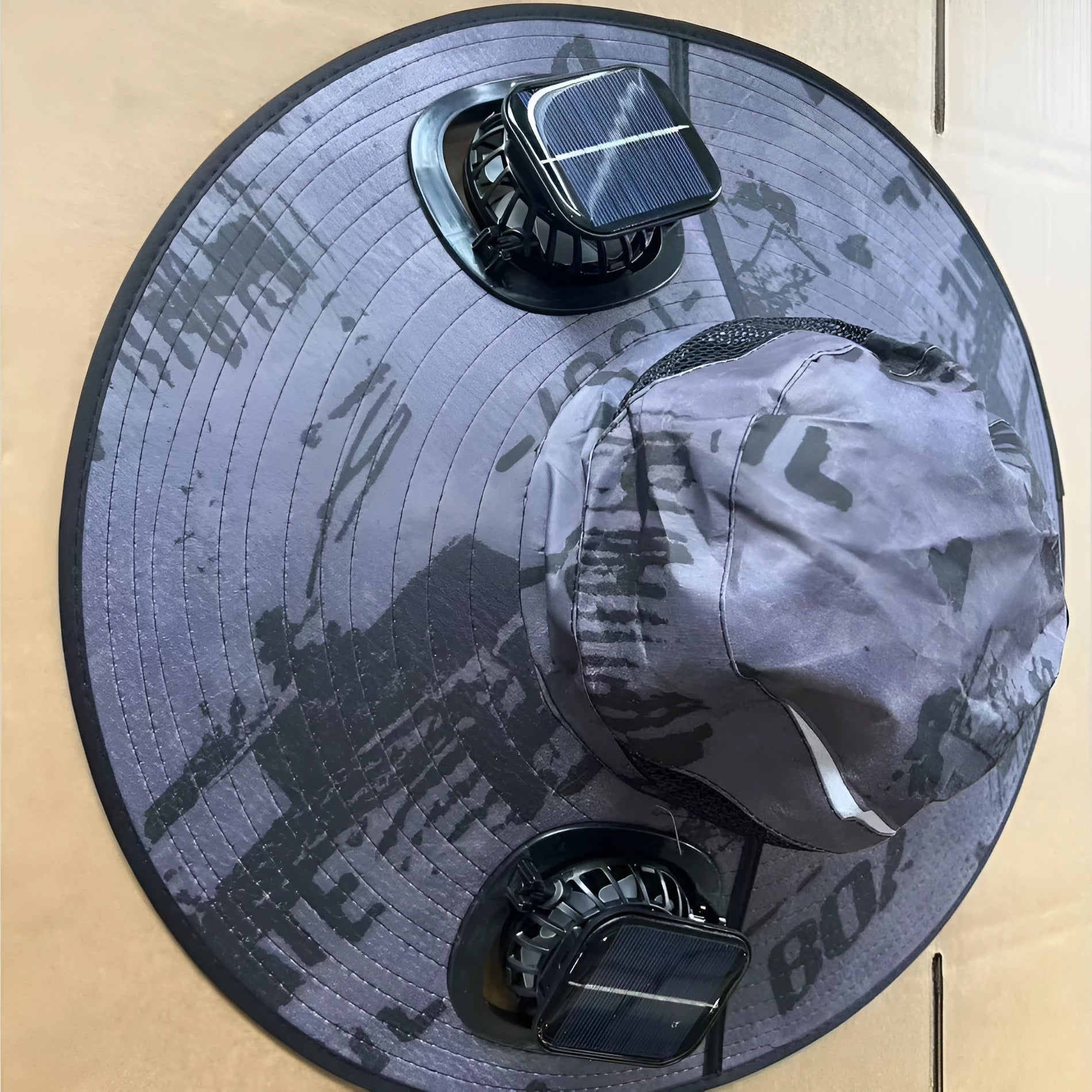 Men's grey solar cooling cap with large eave and visible fan unit on the front.