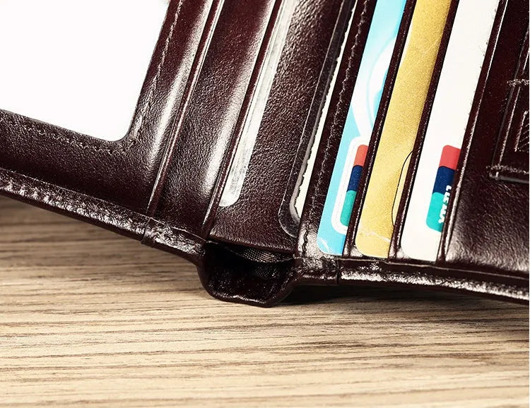 Men's black leather bi-fold wallet open to show card slots, banknote compartment, and coin pocket.