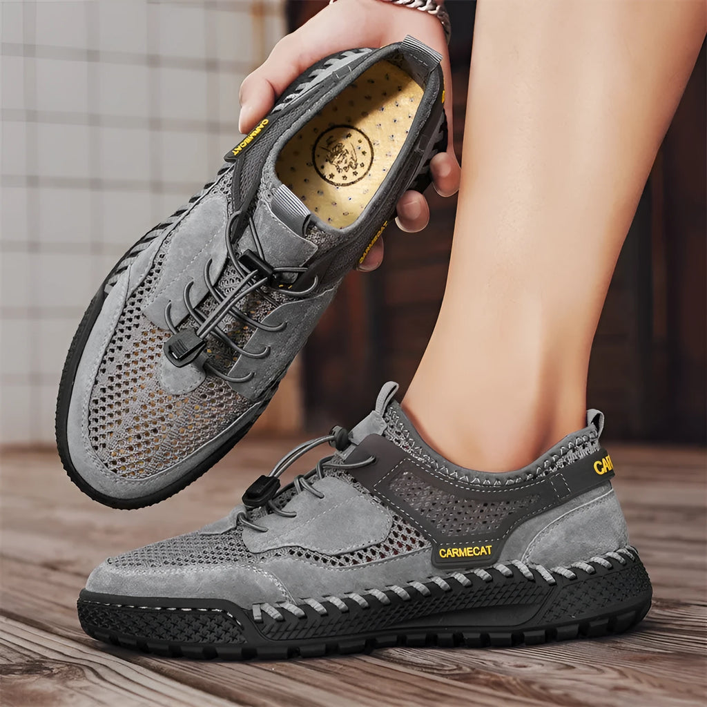 Men's brown suede low-top casual tennis shoes with a visible elastic band and hand-stitched rubber sole.