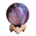3D-printed sphere lunar night light on a base with a remote control.
