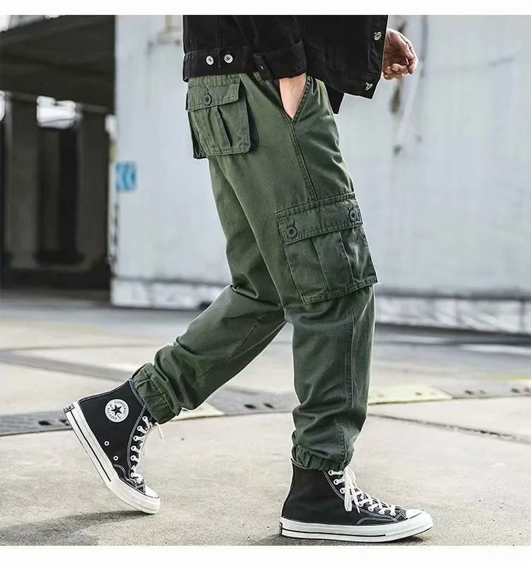 Men's black cotton overalls with loose cropped fit, ankle banded hem, and multiple pockets