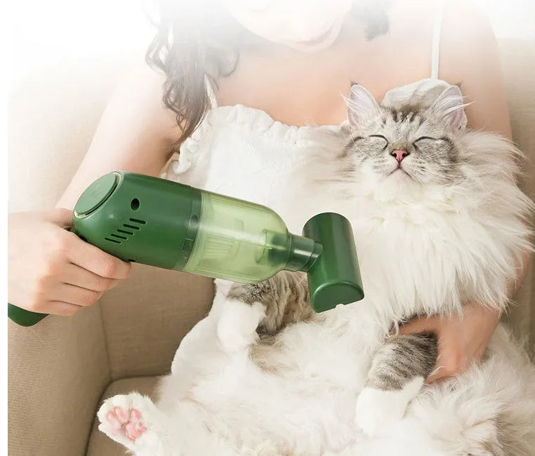 Green electric cat hair cleaner with suction heads for beds
