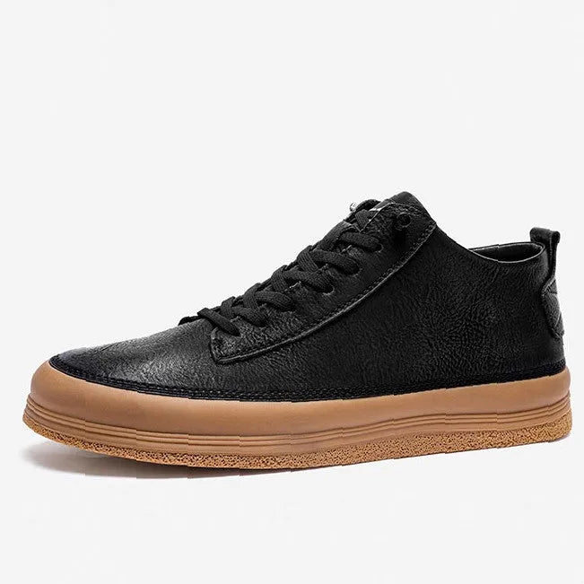 Men's black leather casual shoes with a round toe and white rubber sole on a plain background.
