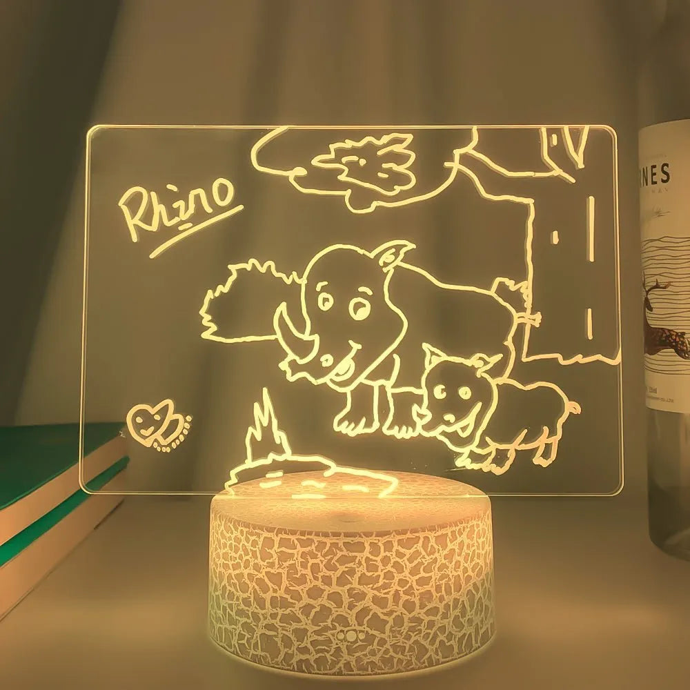 3D light handwritten acrylic message board with black crack base, showing handwritten text and coloured LED night light in use on a desk
