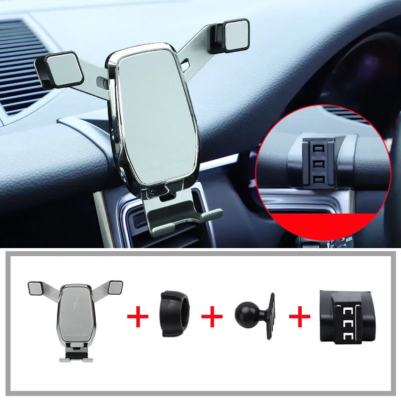 Gravity linkage car phone holder for Porsche in black alloy and carbon fibre, with phone mounted for navigation