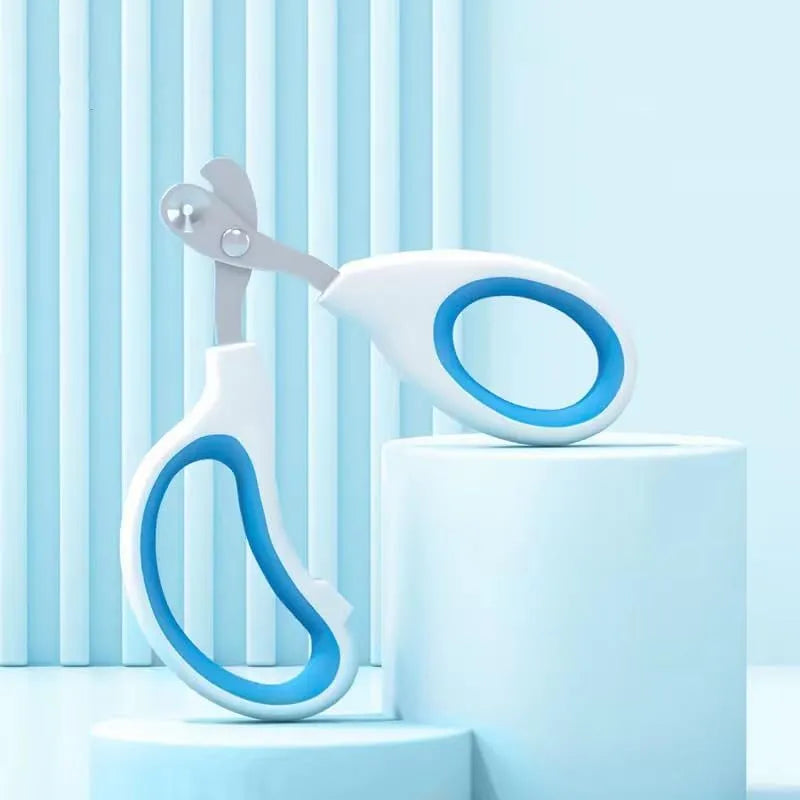 Blue pet nail clippers with circular hole design and cushioned handle on a white background.