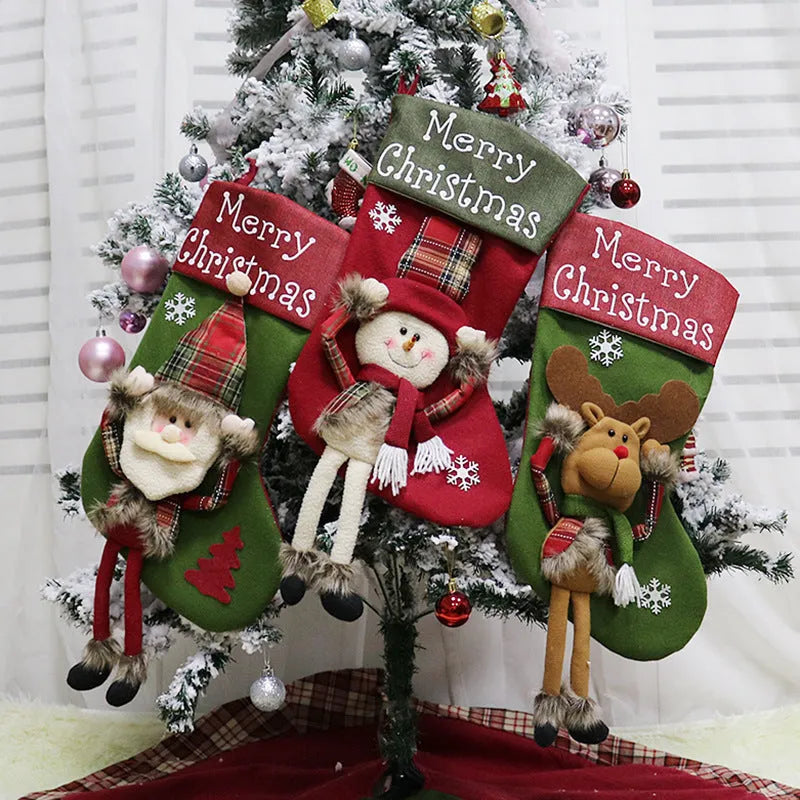 Three large Christmas stockings with Santa, Snowman and Reindeer 3D designs hanging for holiday decoration