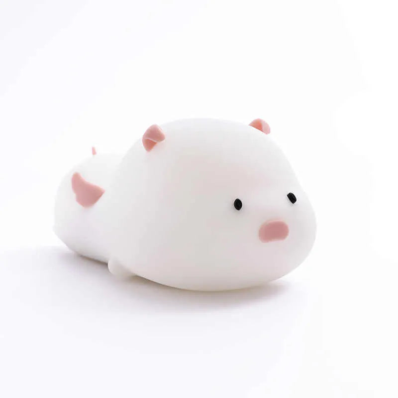 Blue silicone pig-shaped night light with sleeping design and USB charging port
