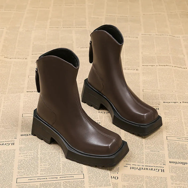 Black women's platform Martin boots with a square toe, high heel, and back zipper on a neutral background.