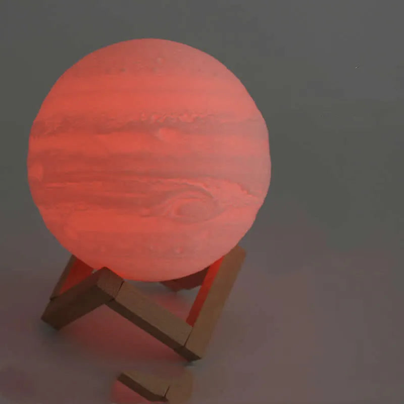 3D printed white moon lamp on wooden stand with touch-sensitive metal ring at base.