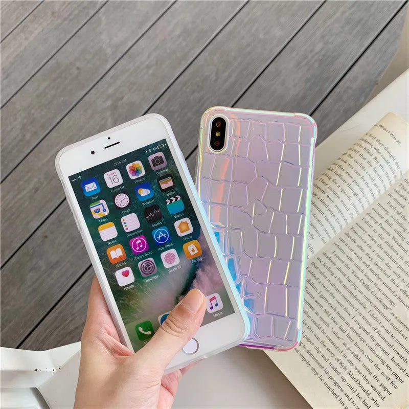 Glossy silver silicone phone case with a laser-etched irregular texture for iPhone, showing raised camera protection.