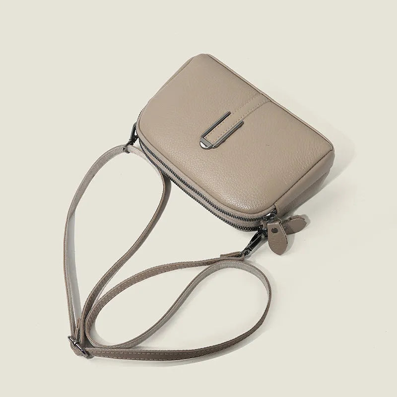 Minimalist crossbody bag in top-grain leather, horizontal square shape, available in five colours including khaki and black