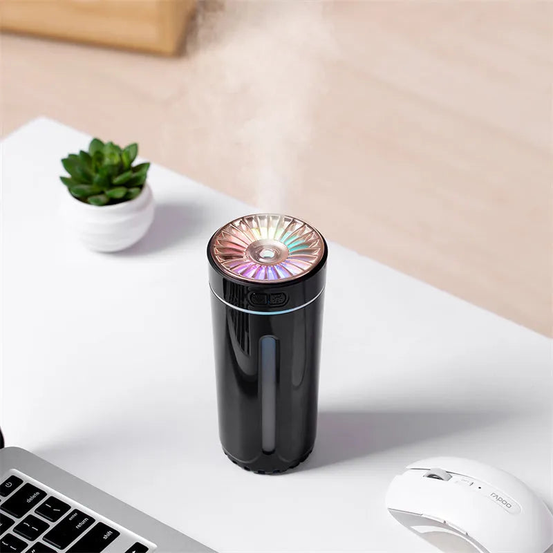 Portable black USB humidifier with colourful lights on car cup holder