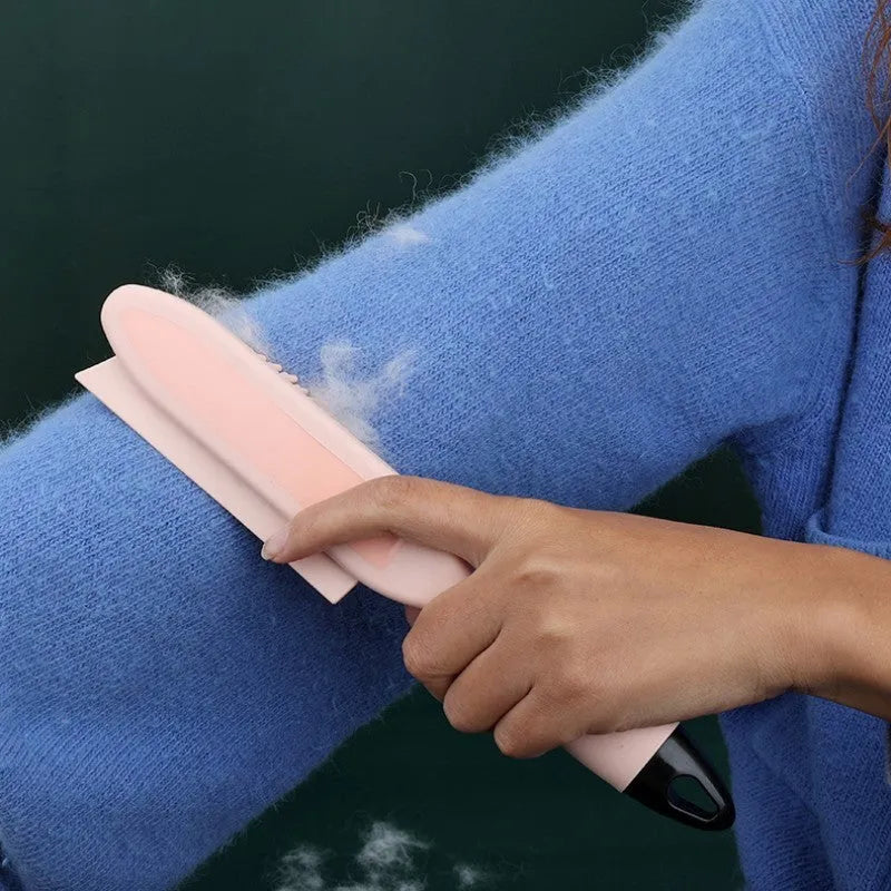 Green dog brush with hair collector reservoir, massage nodules, and a separate pink wool sticker for pet hair removal