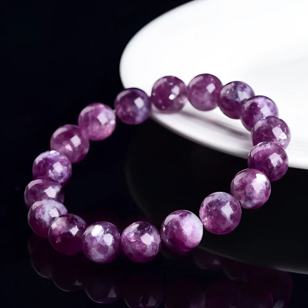 Polished geometric crystal bracelet in purple and pink hues on wrist.