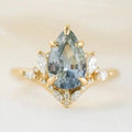 Gold alloy floral ring with aquamarine crystal centre on white background