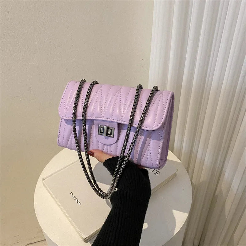 Retro textured diamond pattern women's small handbag in a choice of colours showing front view and internal phone pocket.
