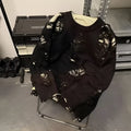 Men's black ripped sweater with animal pattern and tassels on front