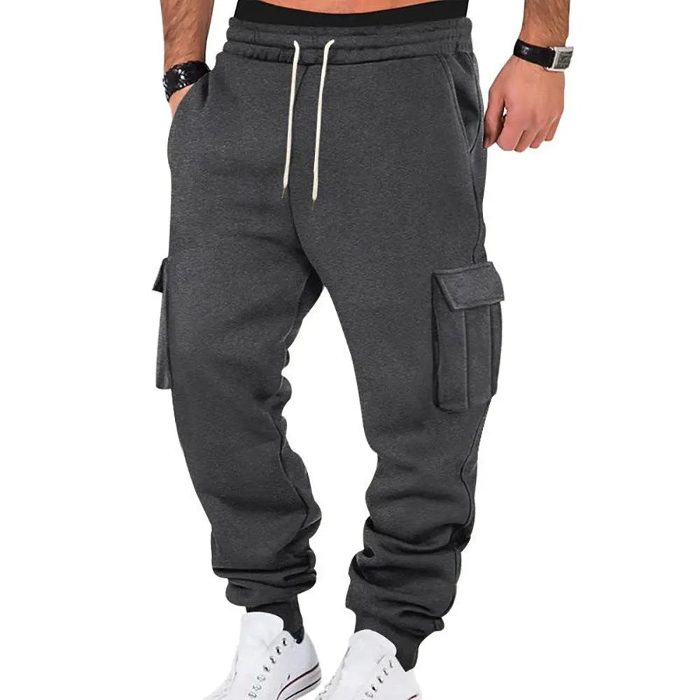 Men's solid colour casual multi-pocket drawstring sports pants in black, featuring polyester fabric and mid-waist design