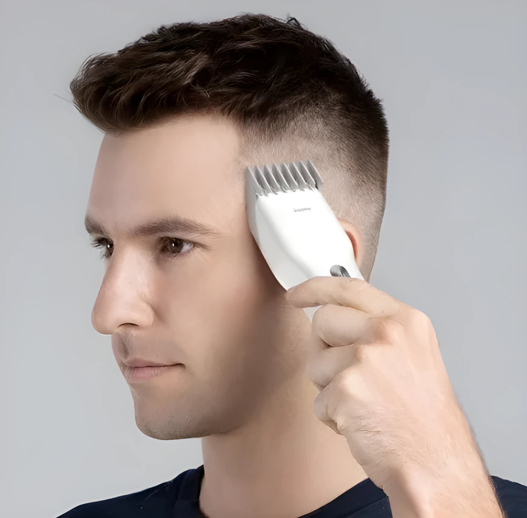 Black and white cordless men's hair clipper with ceramic cutter head and adjustable comb.