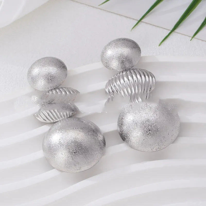 Retro women's polka dot metal bead drop earrings in frosted gold finish on a neutral background