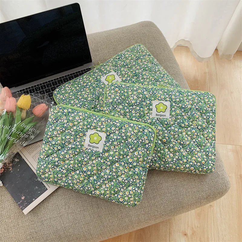 South Korean Ins cotton tablet handbag in green flower pattern with zipper closure on a table