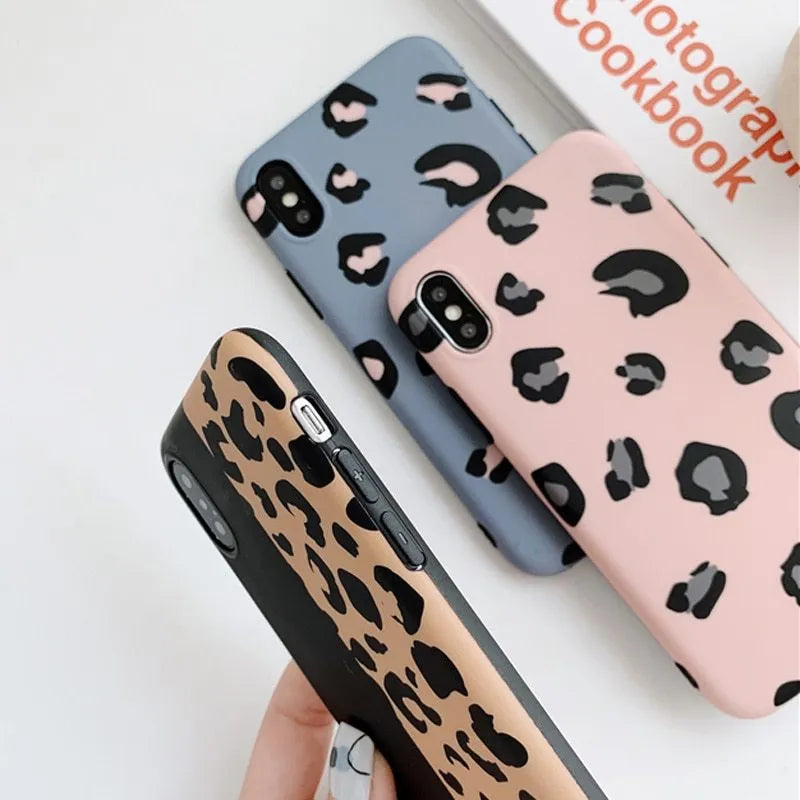 Leopard print mobile phone case for iPhone in black, blue, and pink colours