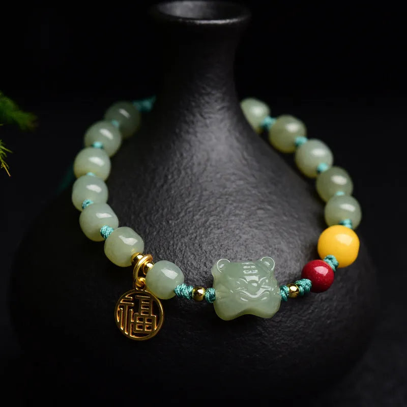 Natural Hetian jade bracelet with cinnabar and beeswax beads featuring animal modelling