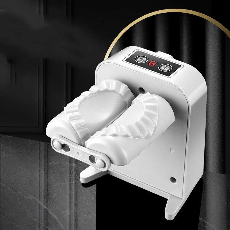 White automatic electric dumpling maker machine with charging cable, brush, and spoon.