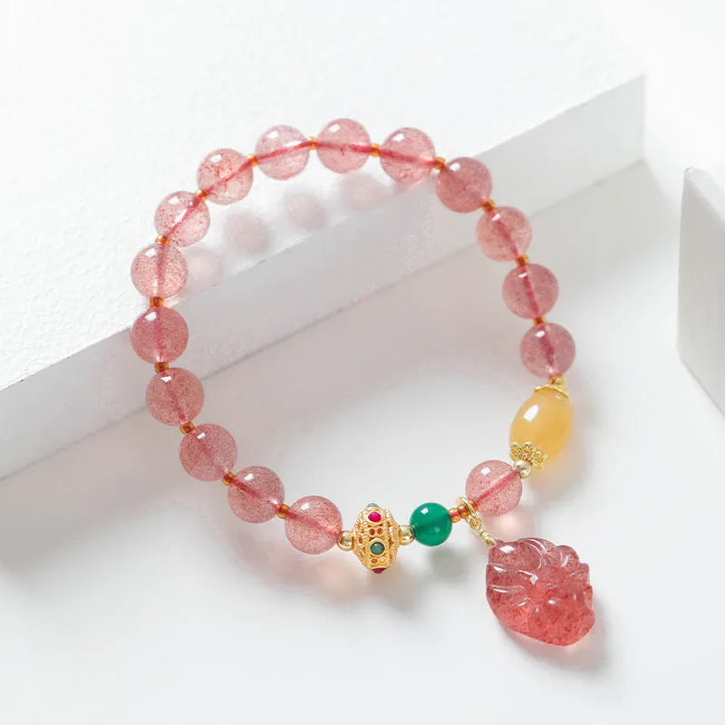Women's Nine Tail Fox design bracelet with polished strawberry quartz crystal beads.