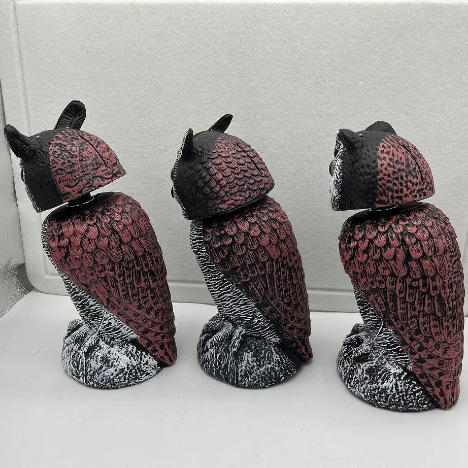 Artificial owl bird deterrent ornament with shaking head design in outdoor garden setting