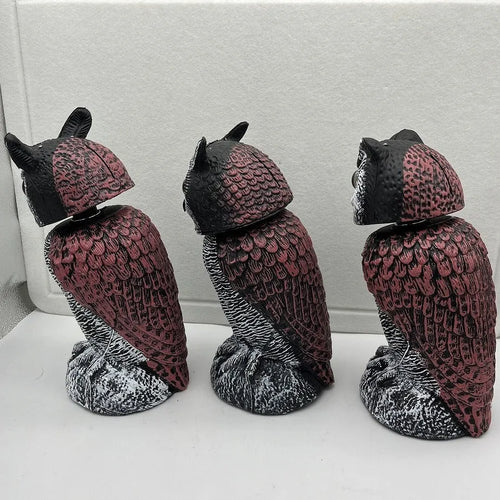 Artificial owl bird deterrent ornament with shaking head design in outdoor garden setting