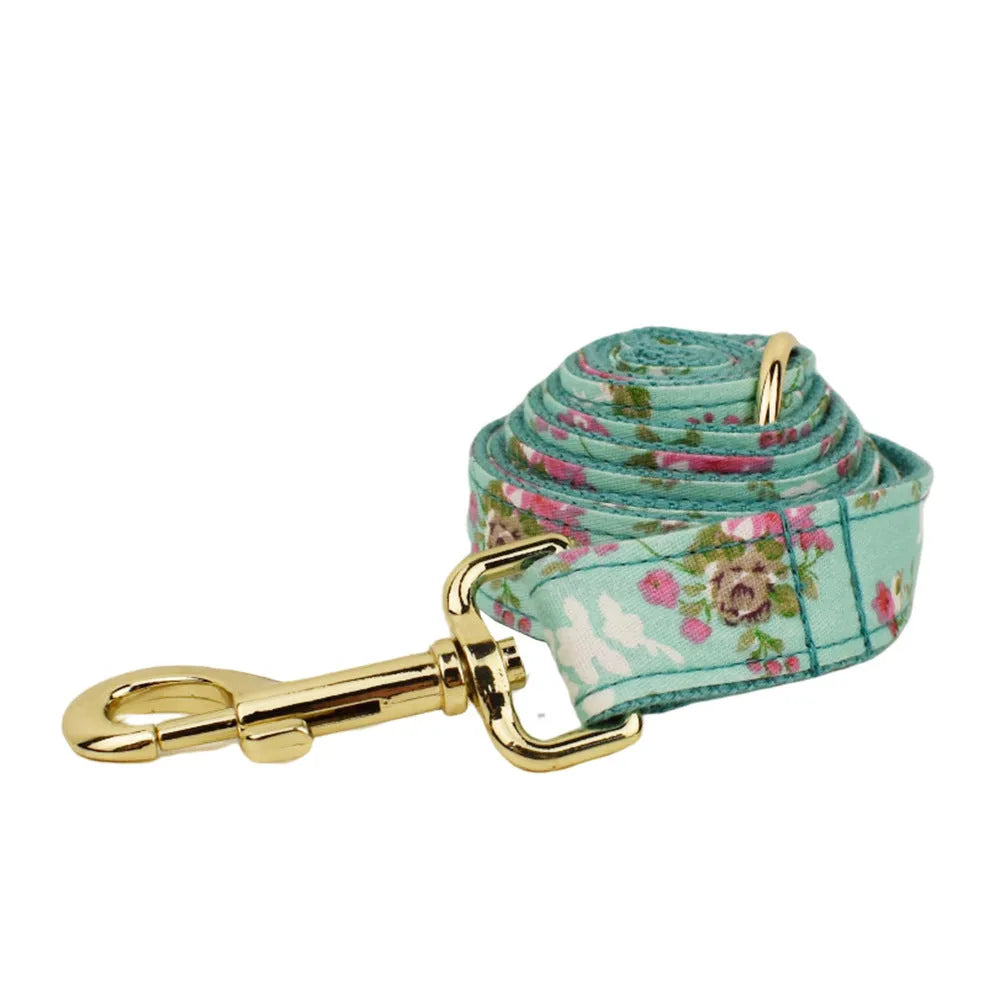Rose print dog collar set with green background including collar, leash, detachable bow, and vest