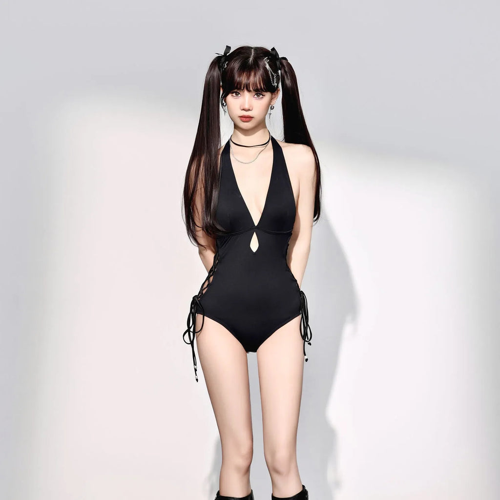 Black women's one-piece swimsuit with V-neckline and hollow strap design on mannequin