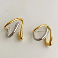 Gold and silver irregular triangle alloy stud earrings with sterling silver needle on neutral background