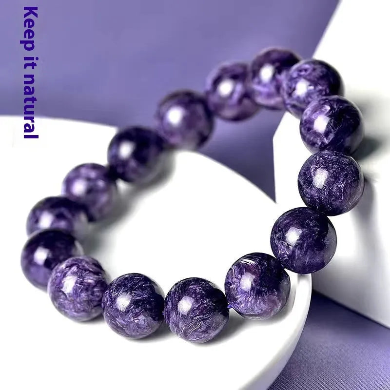 Natural transparent charoite crystal bracelet with platinum metal accents in hands bead design