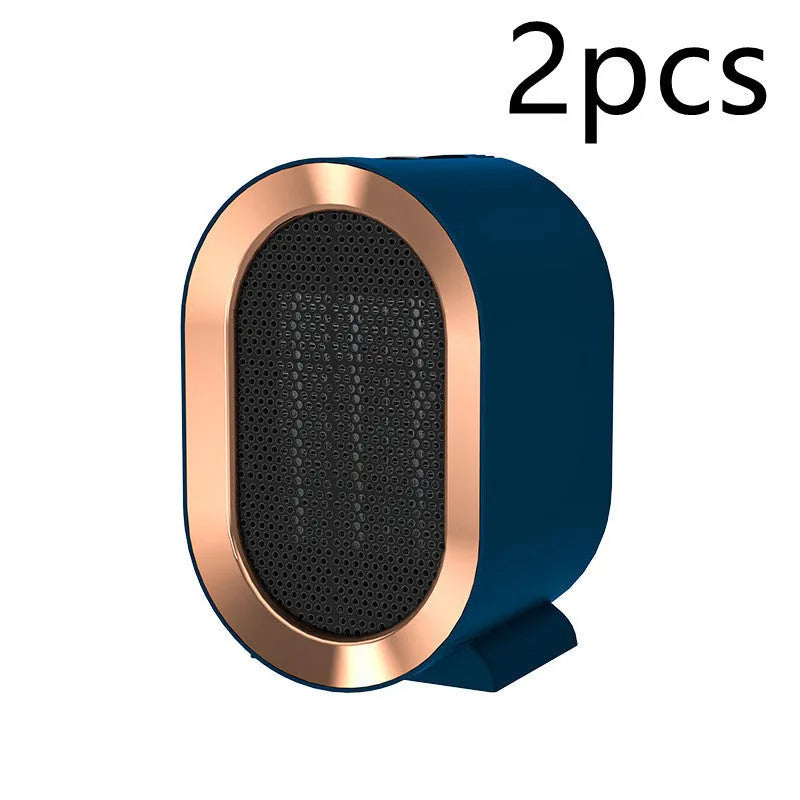 Desktop electric fan heater with black casing and UK plug, showing control knob and air vents
