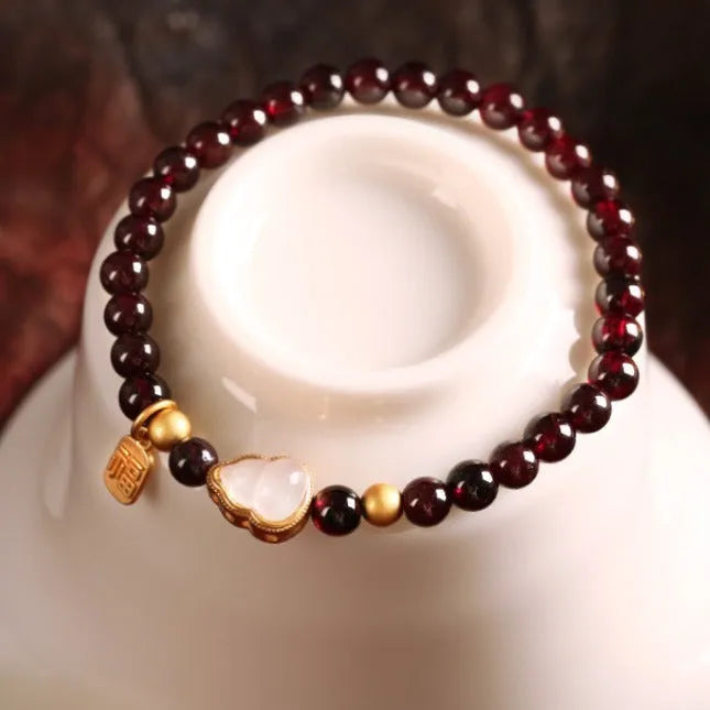 Chinese style gourd bracelet with imitation garnet stones and cultural motifs including Fu character design