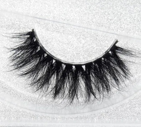 Pair of faux mink eyelashes with long tail and cotton stem against white background