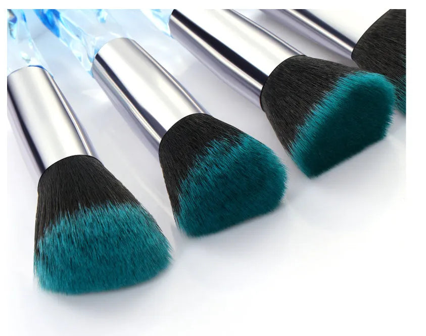 Ten crystal-handle foundation brushes with artificial fibre bristles in a set, showing black, blue, red, and yellow colour options.